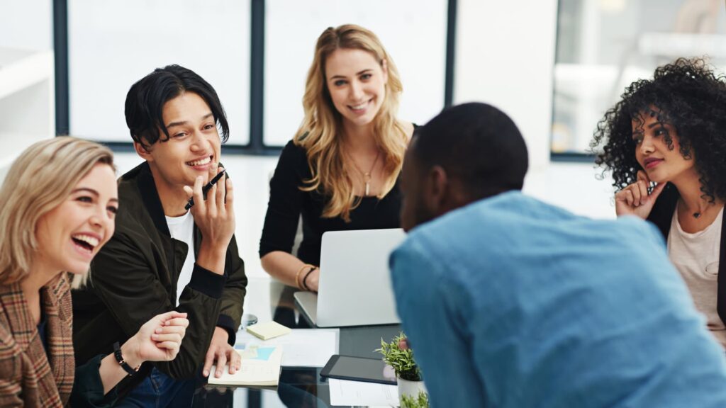 table of individuals in conversation representing a collaborative atmosphere focused on talent engagement.